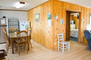 a kitchen and dining room with a table and chairs at Do-Little Dock in Holden Beach