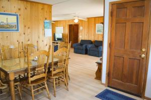 a dining room and living room with a table and chairs at Do-Little Dock in Holden Beach +32 photos