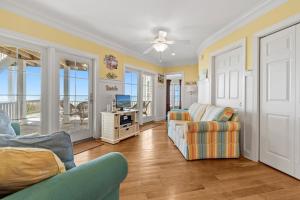 a living room with two chairs and a television at Inn Between in Holden Beach