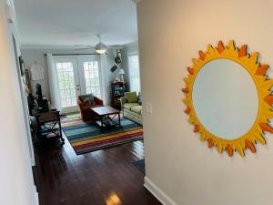 a living room with a large mirror on the wall at Compass Rose in Holden Beach