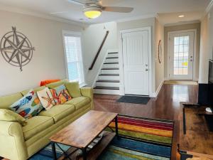 a living room with a couch and a table at Compass Rose in Holden Beach