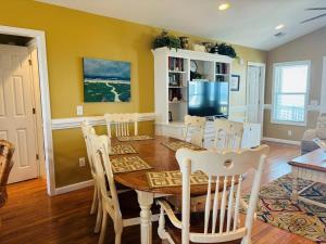 a dining room with a table and chairs at Sea Biscuit in Holden Beach