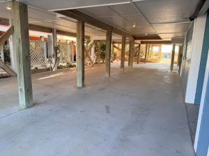 an empty hallway of a building with columns at Majak Moments in Holden Beach