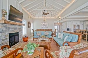 a living room with a blue couch and a fireplace at Cinnamon Sands home in Holden Beach