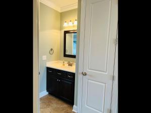 a bathroom with a sink and a mirror at 287 OBW home in Holden Beach