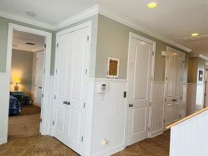 a room with white walls and white closet doors at 287 OBW home in Holden Beach