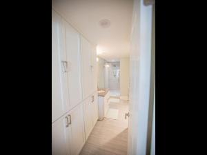 a bathroom with white cabinets and a sink in it at The Sandbox home in Holden Beach
