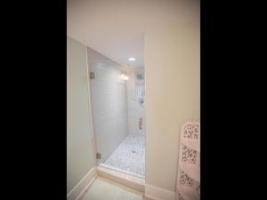 a bathroom with a walk in shower next to a walk in shower at The Sandbox home in Holden Beach +27 photos