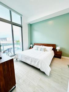a bedroom with a large bed and a large window at Sleek 2BD 2BA Condo In Miami Design District in Miami