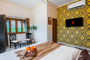 a bedroom with a bed with a tray of oranges on it at Next-stay in Udaipur