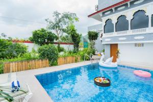 a swimming pool in a house with a pool slide and a pool noodle pool at Next-stay in Udaipur