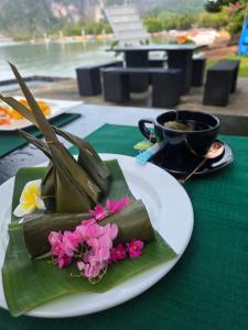 a plate of food with flowers and a cup of coffee at Blue Orchid Beach Krabi - SHA Certified in Ao Nam Mao