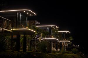 a building lit up at night with lights at Lua Mazamitla in San Luis Soyatlán