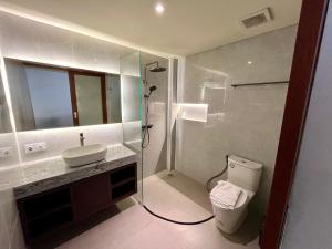 a bathroom with a toilet and a sink and a shower at Taman Agung Hotel in Sanur +29 photos