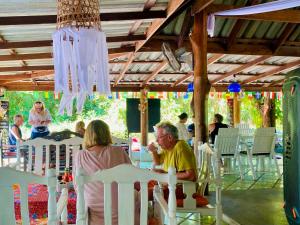 a group of people sitting in chairs at a table at Lucky Resort in Ko Phayam