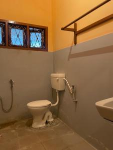 a bathroom with a toilet and a sink at Oakville in Mysore +49 photos