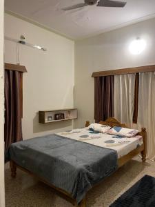 a bedroom with a bed and a ceiling at Oakville in Mysore