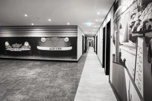 a hallway of a store with a room with displays of shoes at INNSiDE by Meliá Wolfsburg in Wolfsburg