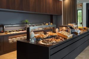 a buffet line with many different types of pastries at Meliá Luxembourg in Luxembourg +57 photos