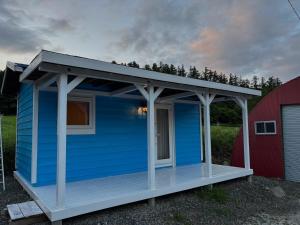 a blue house with a roof on top of it at Ehana Cofee Roastery Hanare in Kami-furano +6 photos