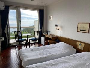 Postel nebo postele na pokoji v ubytování Hotel Cliffside