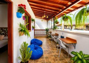 a room with tables and chairs and plants at Hotel Jardin de Rosas in Jardin