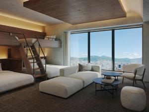 a bedroom with bunk beds and a view of the city at FAV LUX Asahikawa in Asahikawa