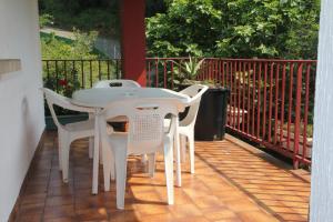 a white table and chairs on a patio at Pensión Tximistarri in San Sebastián