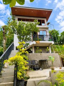 a house with stairs leading up to it at R&C Transient House in El Nido