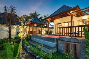 a house with a pathway leading up to it at Dewi Kunti Villa in Tegalalang