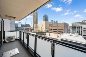 a balcony with a view of a city skyline at Hotel Piacere NAMBA in Osaka