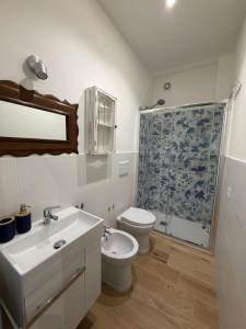 a bathroom with a sink and a toilet and a shower at Lulù Marin Rooms in Scalea