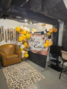 a room with a stage with a chair and balloons at Atlanta 3 Bedroom Home - by PriMary EVolution Properties in Atlanta