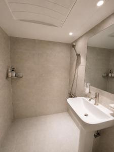 a bathroom with a sink and a mirror at Olli Haus in Seoul