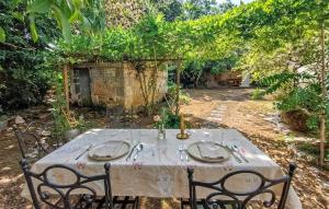 a table with a white table cloth on it at Charmante Maison 