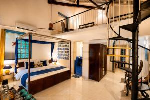 a bedroom with a bunk bed and a spiral staircase at Casa Do Leão - Heritage Boutique Stay in Nerul