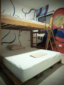 a bedroom with two bunk beds and a ladder at Multiverse Hostel in Medellín +21 photos