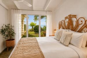 a bedroom with a large bed and a window at Cairns Beachfront Retreat in East Trinity +22 photos