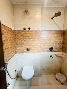 a bathroom with a toilet and a shower at Hotel Royal Green - Green Park Metro in New Delhi