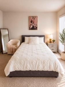 a bedroom with a large bed and a chair at 1-Bedroom Apartment near ALX Airport and the Ocean in Los Angeles