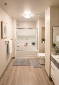 a bathroom with a tub and a toilet and a sink at 1-Bedroom Apartment near ALX Airport and the Ocean in Los Angeles +13 photos