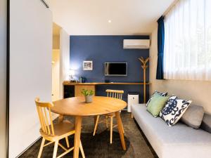 a living room with a table and a couch at Nagi Kurashiki Hotel&Lounge in Kurashiki