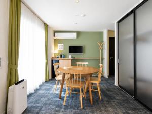 a dining room with a table and chairs at Nagi Kurashiki Hotel&Lounge in Kurashiki