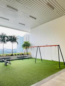 an empty room with a swing and grass at Chambers Elite Suites KLCC in Kuala Lumpur
