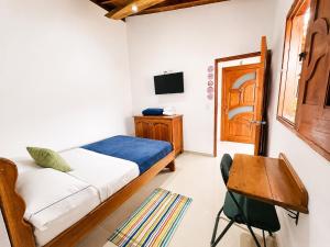 a bedroom with a bed and a table and a chair at Hotel Jardin de Rosas in Jardin +68 photos