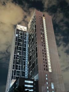 a tall building with a sky in the background at Chambers Elite Suites KLCC in Kuala Lumpur