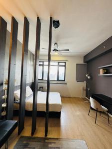 a bedroom with a bed and a table and a couch at Chambers Elite Suites KLCC in Kuala Lumpur +26 photos