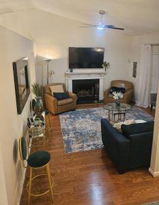 a living room with a couch and a fireplace at Atlanta 3 Bedroom Home - by PriMary EVolution Properties in Atlanta