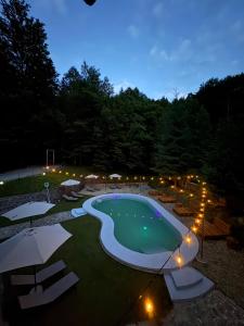 a swimming pool at night with lights around it at Cabana Xtreme - Valiug in Văliug +9 photos