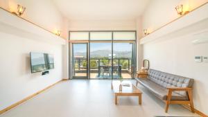 a living room with a couch and a table at goseong theprism pension in Goseong